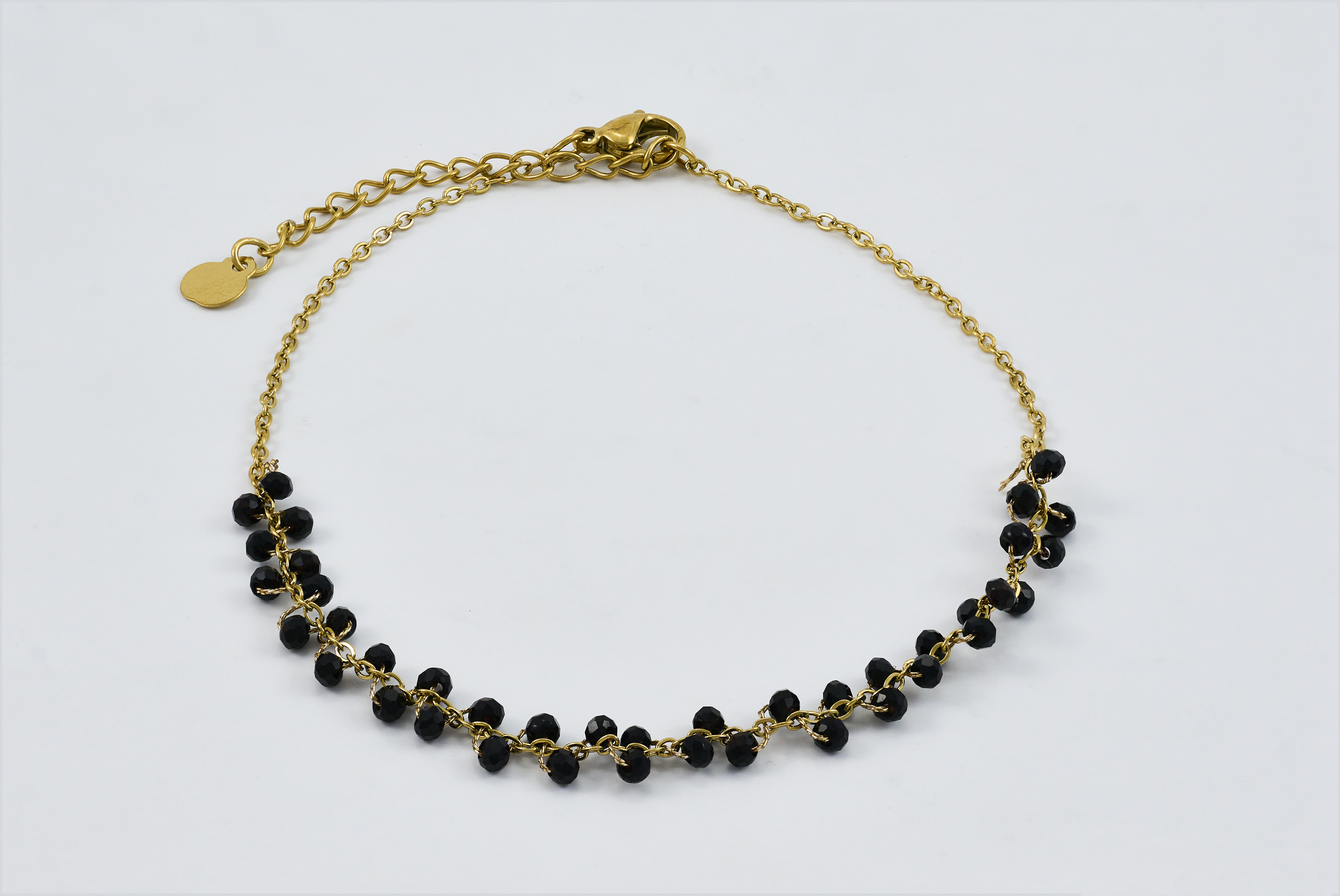 Chique gouden enkelband met zwarte kralen